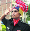 An Army jawan pays tributes to martyr Capt Roopinder Garcha in Jalandhar on Monday.