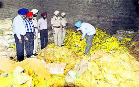 Policemen and officials of the Agriculture Department at the fertiliser unit on Hambran Road in Ludhiana on Monday.
