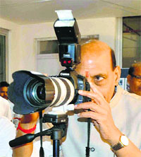 Union Home Minister and Lucknow MP Rajnath Singh tries his hands on photography during a programme in a school in Lucknow on Monday