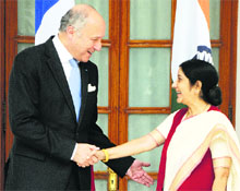 French Foreign Minister Laurent Fabius and Minister for External Affairs Sushma Swaraj shake hands during a meeting in New Delhi on Monday. 