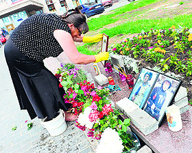 A woman cleans an impromptu memorial for two Russian journalists killed in Lugansk last month. Klyan was the third journalist from a Russian state network to be killed since pro-Russian separatists began an uprising in east Ukraine in April. An Italian journalist and his Russian translator were also killed in May. 