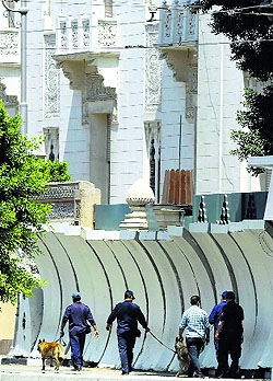 Explosive investigators search for possible bombs in front of the presidential palace in Cairo on Monday.