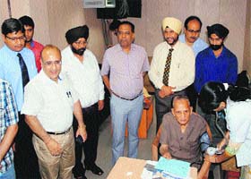 Residents at the health camp organised by the local branch of Institute of Chartered Accountants of India at the Income Tax Office  in Amritsar on Tuesday