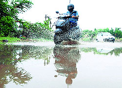 A scooterist makes his way through a waterlogged road after rain in Chandigarh on Tuesday