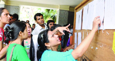 Delhi University aspirants check out the first cutoff list at the Faculty of Arts, North Campus on Tuesday.