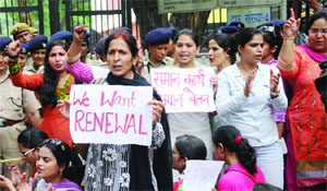 Delhi government school guest teachers clamour for regularisation of their jobs, at the Human Resource Development Ministry in New Delhi on Tuesday.