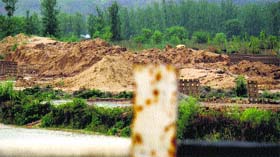 Riverbed encroached upon at Dusahra village on the Una-Amb highway.
