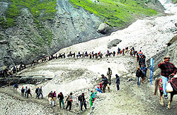 Pilgrims walk over a glacier on way to the Amarnath cave shrine