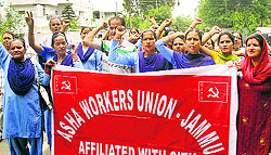 Members of the Asha Workers Union protest in Jammu on Tuesday