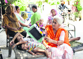 Unscheduled power cuts force women to sit outside their houses in Jalandhar on Wednesday