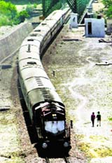 A train passes through bridge during a trial run at the Delhi-Katra rail link near Jammu.