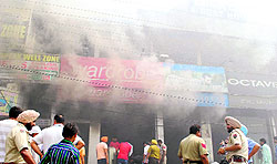 Smoke comes out of three shops in Amritsar on Wednesday