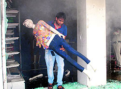 An employee of the shop brings out a mannequin
