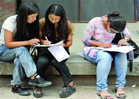 Delhi University aspirants fill the forms before submitting documents for admission at Miranda College,  North Campus, on Wednesday