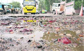 A bus passes through a rough patch at the bus stand in Jalandhar on Wednesday