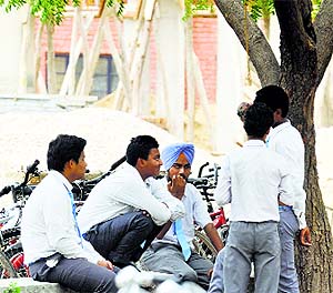 Students chat during recess after returning from summer vacation at Government Model Senior Secondary School, PAU, in Ludhiana.