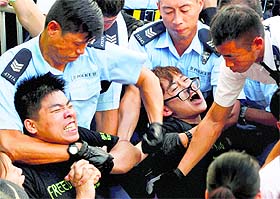 Protesters are taken away by the police after protesters staged a peaceful sit-ins in Hong Kong to show their support for democratic reform and oppose Beijings desire to have the final say on candidates for the chief executives job.