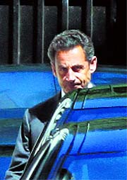 Former French President Nicolas Sarkozy leaves his home in Paris on Wednesday.