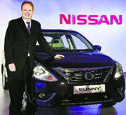 Nissan Motors Corps chief planning officer Andy Palmer poses with new Sunny at its launch in Mumbai on Thursday. The car has been launched both in petrol and diesel variants priced between Rs 7.29 and Rs 10.22 lakh (ex-showroom Mumbai)