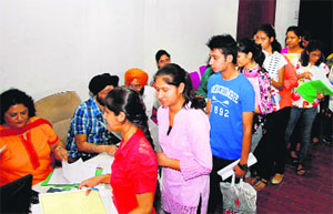 Students queue up to submit admission forms at Panjab University on Thursday.