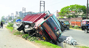 The truck that got stuck in an open drain on the NH-1 near the Jalandhar bypass in Ludhiana on Thursday 