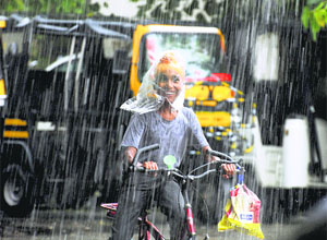 A boy enjoys the sudden showers in Ludhiana on Thursday.