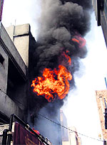 Fire billows from the shop