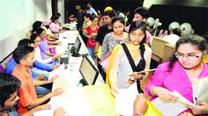 Students queue up to submit admission forms at the law auditorium of Panjab University in Chandigarh on Friday