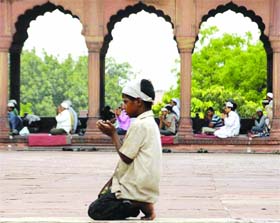 Muslim devotees offer prayers at Jama Mosque in New Delhi on Friday.