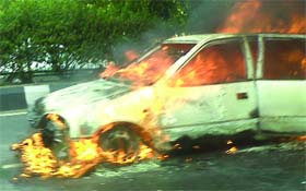 A car catches fire near Subroto Park in New Delhi on Friday