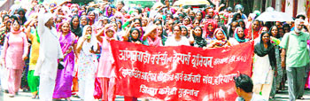 Anganwadi workers and helpers protest at Fatehabad on Friday.