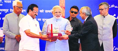Minister of Railways DV Sadananda Gowda (right) and chairman, Railway Board, Arunendra Kumar present a memento to Prime Minister Narendra Modi after flagging off the train service to Katra at the Katra railway station on Friday. Governor NN Vohra and Chief Minister Omar Abdullah are also seen in the picture.