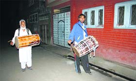 Human alarms: Saharkhans (drummers) go about their duty to wake up people for pre-dawn meals during Ramadan in Srinagar.