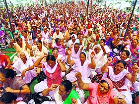 Members of the Anganwadi Mulazam Union, Punjab, shout slogans outside the Mini-Secretariat in Ludhiana on Friday.