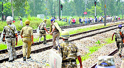 Policemen charge at BJP supporters during a clash at Kanth railway station in Moradabad district of Uttar Pradesh on Friday