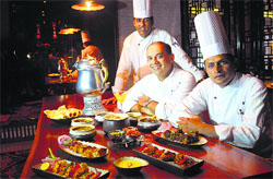 (L-R) Chef Shiva Arora, Chef Pallav Singhal and Chef Rayees with the Kashmiri spread. Photo: S Chandan