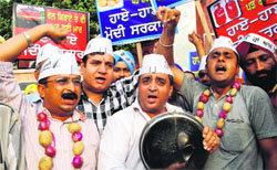 AAP workers hold a protest against hike in petrol, diesel price and rail fares in Amritsar on Saturday. Photo: RK Soni