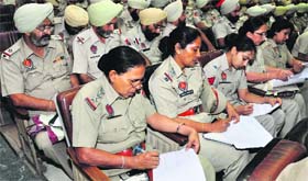 Police personnel write suggestions at a seminar in Mohali on Saturday.