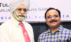 Ex-president of Rotary Club, Chandigarh Midtown, Deepak Sood (right) congratulates his successor Rotarian RTPS Tulsi at CII in Chandigarh on Saturday.
