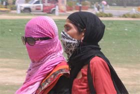 SUNNY SATURDAY: Girls cover themselves with scarves in New Delhi