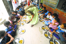 Students consuming the mid-day meal at the Government Primary School Radio Colony in Jalandhar.