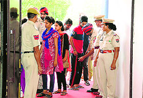Police personnel frisk students of the College of Fisheries before their meeting with Deputy Chief Minister Sukhbir Singh Badal and his wife Harsimrat Kaur Badal, Union Minister for Food Processing Industry, at the PAU in Ludhiana on Saturday.