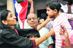 Maureen, one of the nurses, who was stranded in Iraq, holds her daughter upon arrival at the airport in Kochi on Saturday. PTI 