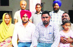 Joginder Singh and Ekam Singh with their family members in Machhiwara on Saturday. Tribune photo