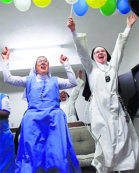  Nuns from the enclosed Imaculada Conceicao monastery in Piratininga, Sao Paulo, celebrate after watching Brazil beat Colombia on TV. 