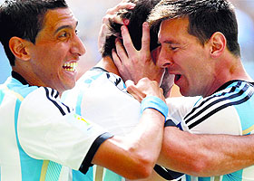 Argentinas Angel Di Maria (L) and Lionel Messi (R) congratulate teammate Gonzalo Higuain for scoring a goal.