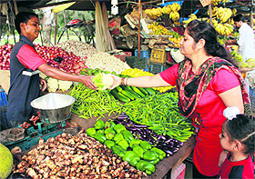 A woman purchases vegetables in Bathinda on Sunday.