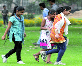 Girls stroll on a wet day at India Gate in New Delhi on Sunday.