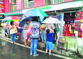 Tourists buy umbrellas in Mussoorie on Sunday