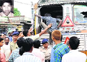 Villagers damage the truck involved in the accident at Mehuwala village in Dehradun on Sunday; and (inset) the victim